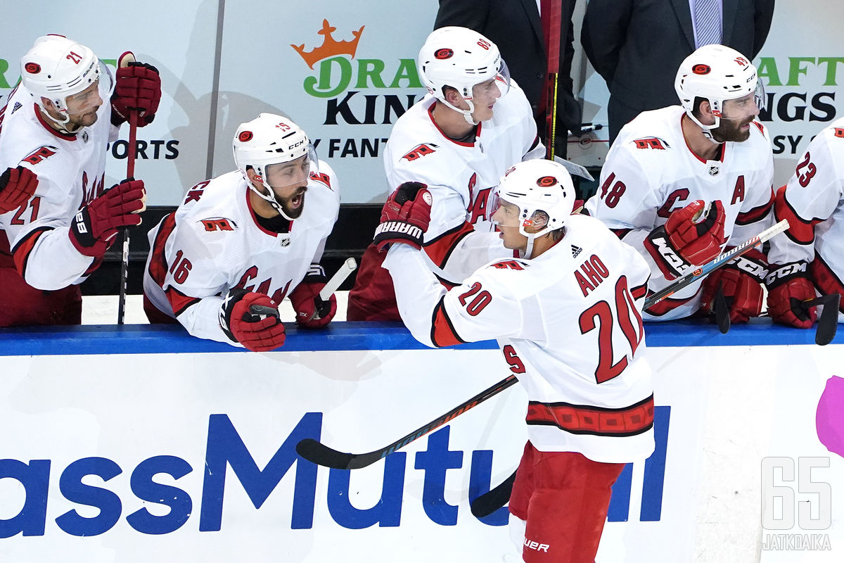 TORONTO, ONTARIO - AUGUST 04: Sebastian Aho #20 of the Carolina Hurricanes celebrates with his teammates after scoring a goal on Igor Shesterkin #31 of the New York Rangers during the third period in Game Three of the Eastern Conference Qualification Roun