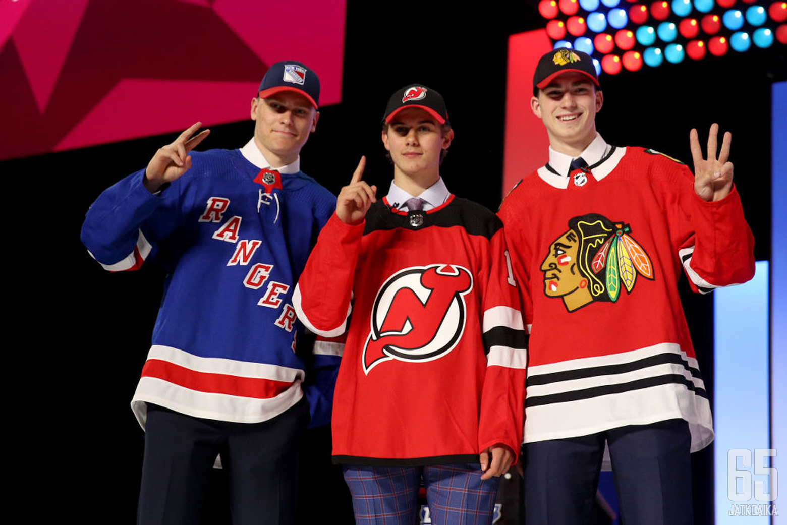 VANCOUVER, BRITISH COLUMBIA - JUNE 21:  (L-R) Kaapo Kakko, second overall pick by the New York Rangers, Jack Hughes, first overall pick by the New Jersey Devils, and Kirby Dach, third overall pick by the Chicago Blackhawks hold up their fingers of their p